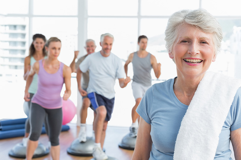 Smiling older woman in an exercise class